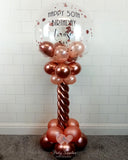 COLLECTION ONLY - Rose Gold Twisted Tower Topped with a Clear Bubble filled with Balloons & Confetti - Black Message