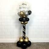 COLLECTION ONLY - Black, Silver & Gold Twisted Tower Topped with a Clear Bubble filled with Balloons & Gold Leaf - Black Message