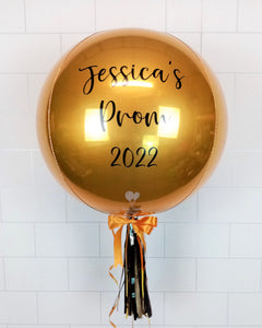 COLLECTION ONLY - Gold Orbz Balloon, Personalised with a Black Message Dressed with Tassel, Bow & Weight