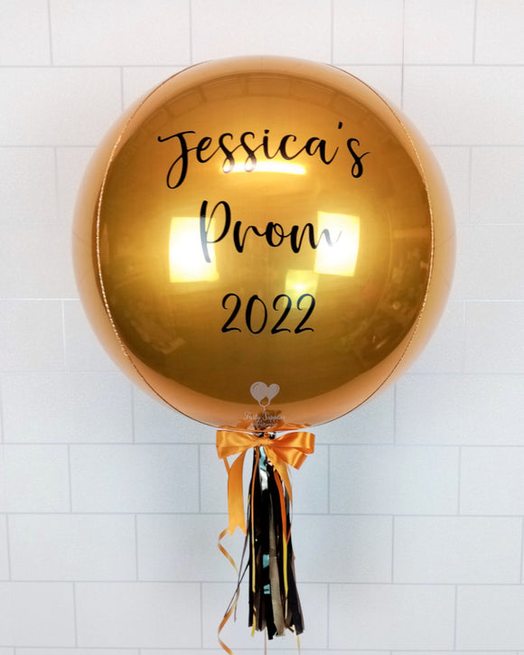 COLLECTION ONLY - Gold Orbz Balloon, Personalised with a Black Message Dressed with Tassel, Bow & Weight
