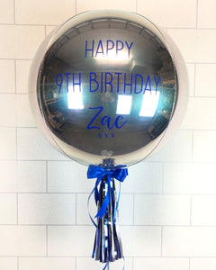 COLLECTION ONLY - Silver Orbz Balloon, Personalised with a Blue Message Dressed with Tassel, Bow & Weight